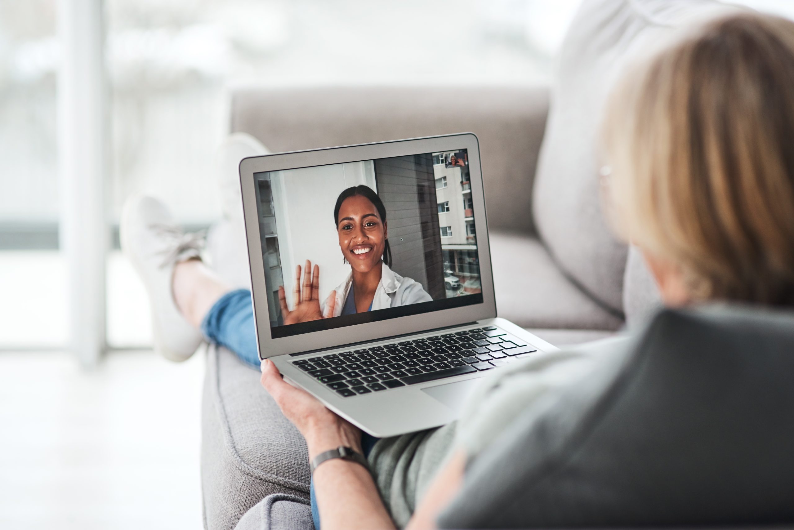 Patient speaking with a Manitoba physician by phone or secure video from home